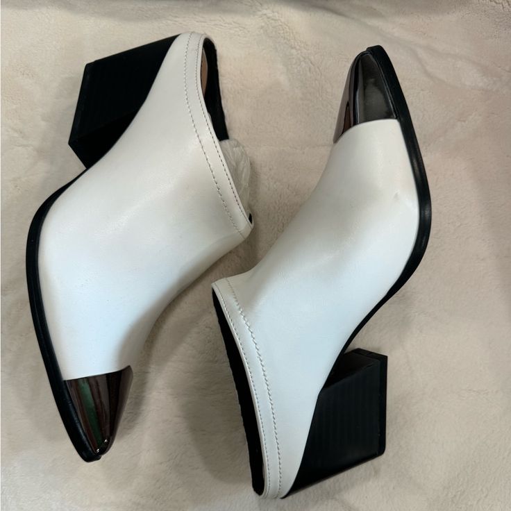 White Heeled Mule Trendy Synthetic Mules With 4-inch Heel, Trendy Synthetic Pointed Toe Mules, Trendy Pointed Toe Faux Leather Heels, White Closed Toe Mules With 4-inch Heel, Synthetic Pointed Toe Mules With Contrasting Heel Counter, Pointed Toe Mules With Contrasting Heel Counter, Modern Faux Leather Heels With Block Heel, Modern Faux Leather Block Heel Heels, Modern Faux Leather Block Heel Shoes