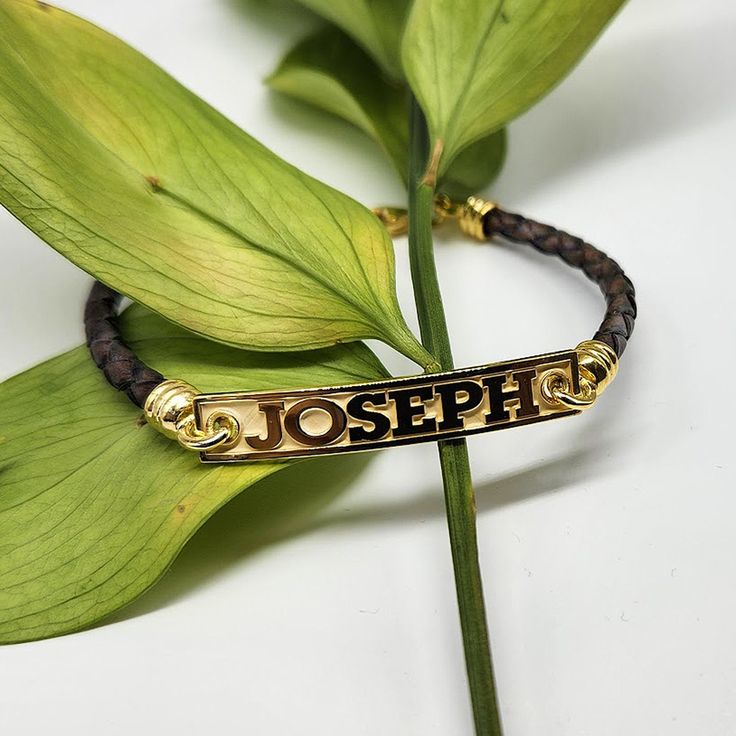 "Details: ~14k  Solid Yellow Gold - 14k Solid White Gold - 14k  Solid Rose Gold - Sterling Silver  ~Genuine Breaded Leather Bracelet ~ID Dimensions: 1.6\" ( 40 mm )  X 0.28\" ( 7.0 mm ) ~14k Gold Lobster Clasp ~14k Gold solid adjustable links Processing Time and Shipping: ~Production time is 7 to 10 business days ~Expedited production is available additional fee applies) ~Standard shipping is free, options to upgrade shipping to (2-4 Days Priority) or (1-2 Day Priority Express) are available dur Personalized Adjustable 14k Gold Bracelets, Adjustable Engraved Gold Wristband, Engravable Nameplate Bracelet In Yellow Gold, Yellow Gold Nameplate Bracelet With Engraving Option, Adjustable Gold Engraved Wristband, Personalized Rectangular 14k Gold Bracelets, Classic Adjustable 14k Gold Name Bracelet, 14k Gold Name Bracelet With Engraving Option, Customizable Yellow Gold Nameplate Bracelet