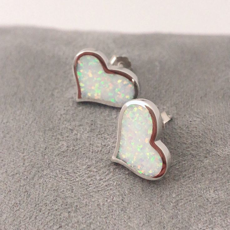 "Love Heart Fire Opal Sterling Silver Stud Earrings, Simple White Opal Studs, Simple Gemstone Earrings, October Birthstone Earrings, hear Opal Earrings' Sterling Silver Fire Opal Stud Earrings. It is made of solid British Sterling Silver and rhodium plating. Rhodium-plated silver is fine sterling silver that is polished and dipped in rhodium. It has a bright finish, similar to white gold items, and it doesn't tarnish. Why do I love to use Opal in my design? I am very passionate about opal becaus White Hypoallergenic Heart-shaped Jewelry, Nickel-free White Sterling Silver Heart Earrings, Nickel-free White Heart Earrings For Anniversary, White Heart Cut Earrings With Heart Charm, White Nickel-free Heart Earrings For Anniversary, White Heart Shaped Earrings For Gift, White Heart Earrings For Gift, White Heart Earrings Gift, White Hypoallergenic Heart Earrings For Anniversary