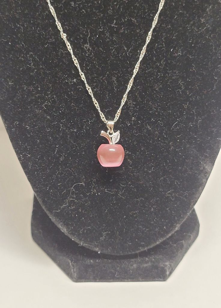 Silver and pink apple ladies necklace Width: 1cm Height: 2cm Chain length: 18in Pink Pendant Jewelry With Clavicle Chain, Pink Adjustable Round Charm Necklace, Adjustable Pink Round Charm Necklace, Adjustable Pink Charm Necklace, Elegant Pink Round Charm Necklace, Elegant Pink Round Charm Necklaces, Pink Pendant Necklace With Clavicle Chain, Adjustable Pink Pendant Charm Necklaces, Pink Round Charm Necklace With Adjustable Chain