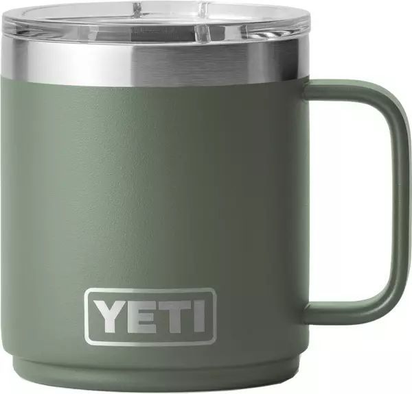 the yeti mug is shown with its lid open and it's in green