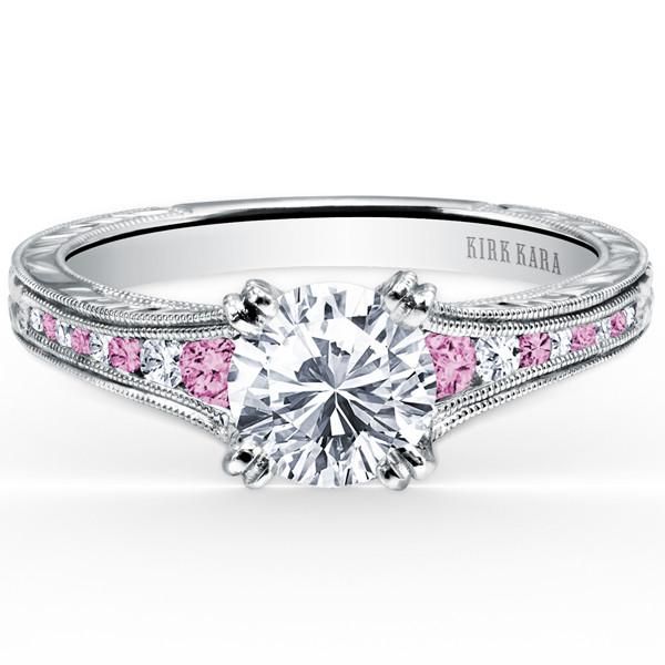 a pink diamond and white gold engagement ring with diamonds on the sides, set in 18k white gold