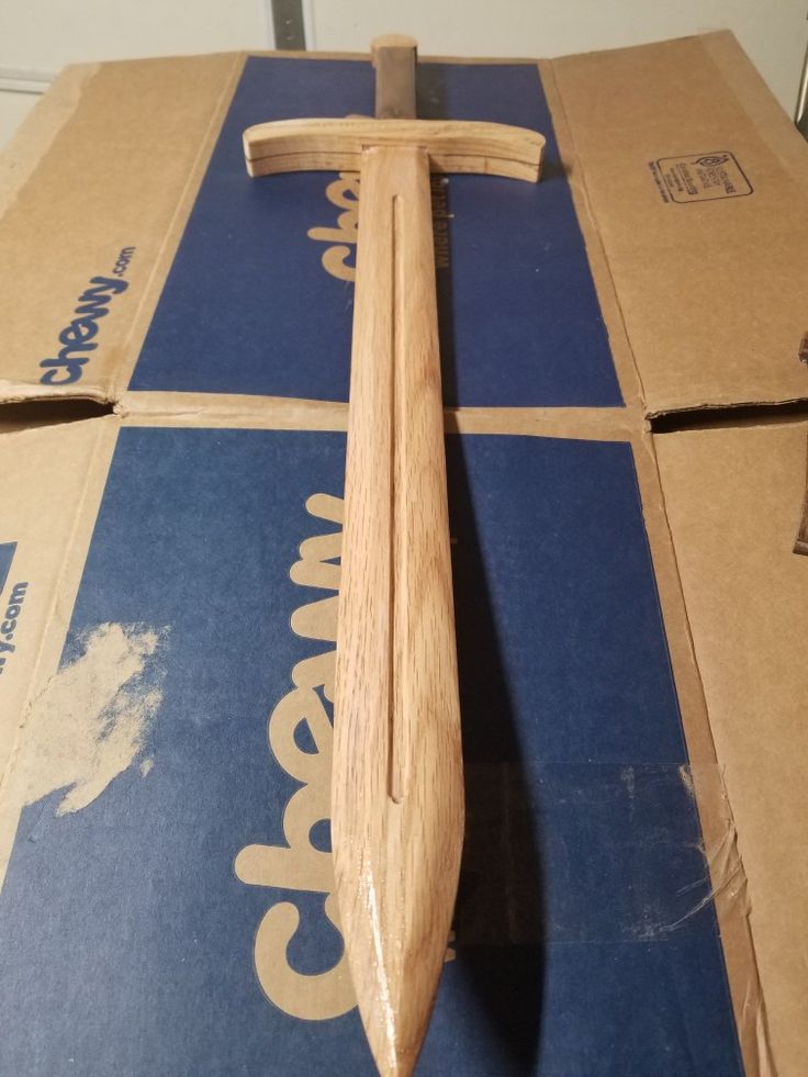 a wooden cross sitting on top of a cardboard box