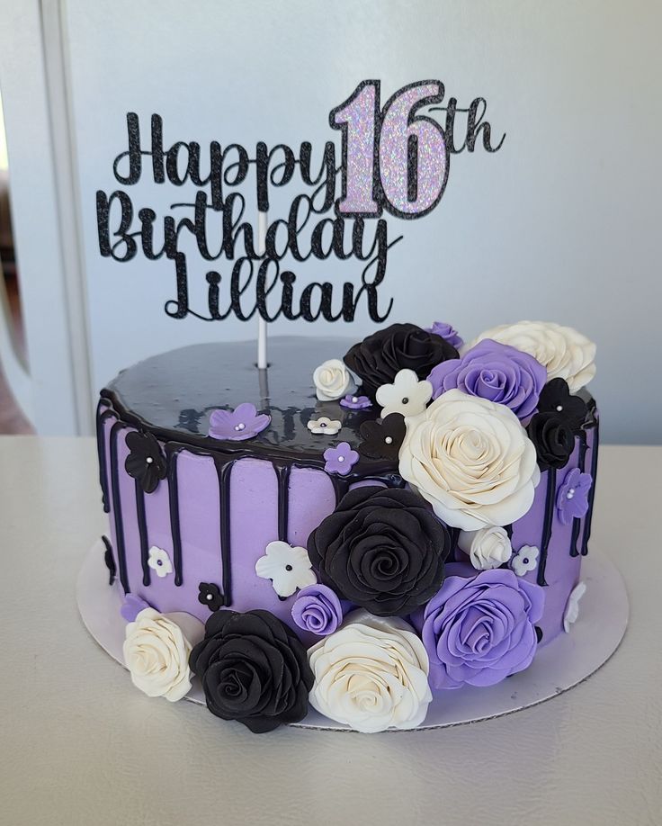 a birthday cake decorated with purple and white flowers