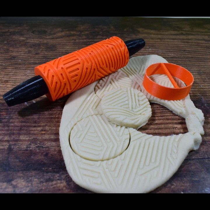 an orange and black object sitting on top of a wooden table next to a pair of scissors