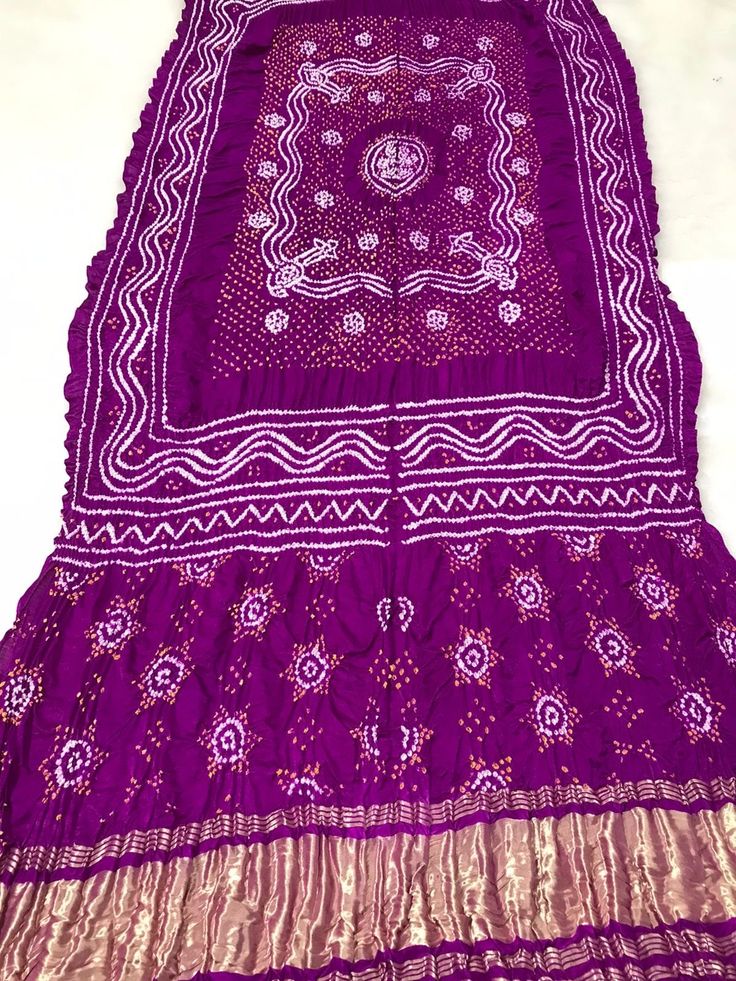 Traditional Pattern Gaji Silk Bandhani Dupatta - 80 Grams Pure Silk This dupatta is made to order, meaning it is created specifically for each individual customer. Therefore, the photo provided is just an example and design variations may occur.  ➢ Manufactured by Indian artisans in Kutch. ➢ Dupatta is non-ironed to leave the original crinkly effect. ➢ Colour of the product may vaguely vary due to the photographic lighting. ➢ The pattern may vary slightly because it is handmade with tie and dye Traditional Purple Dupatta For Ceremonies, Purple Bandhani Print Dupatta, Traditional Purple Dupatta With Cutdana, Traditional Purple Dupatta For Puja, Traditional Purple Dupatta, Traditional Purple Dupatta For Festive Occasions, Traditional Purple Festive Dupatta, Bollywood Style Purple Dupatta For Festivals, Traditional Katan Silk Dupatta With Bandhani Print