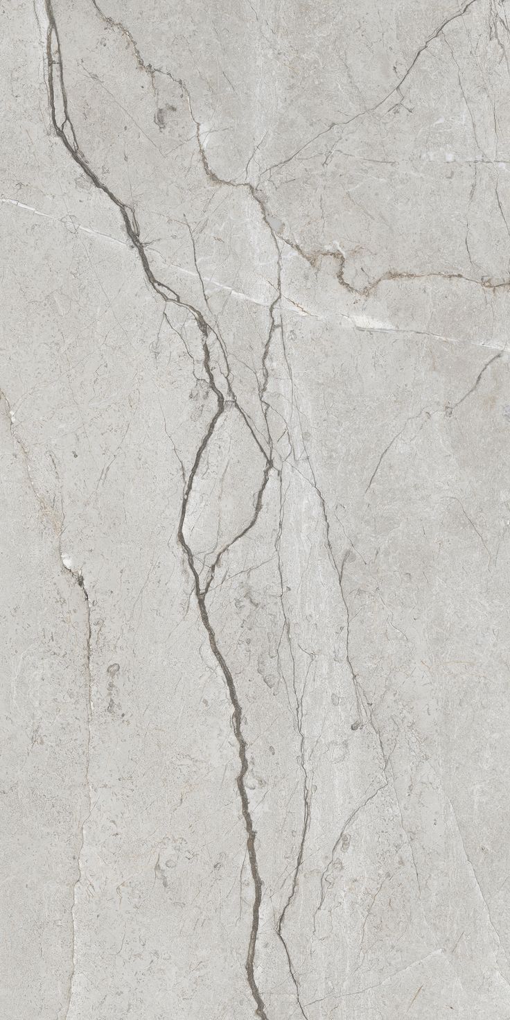 a white marble floor with cracky lines on the side and cracks in the middle