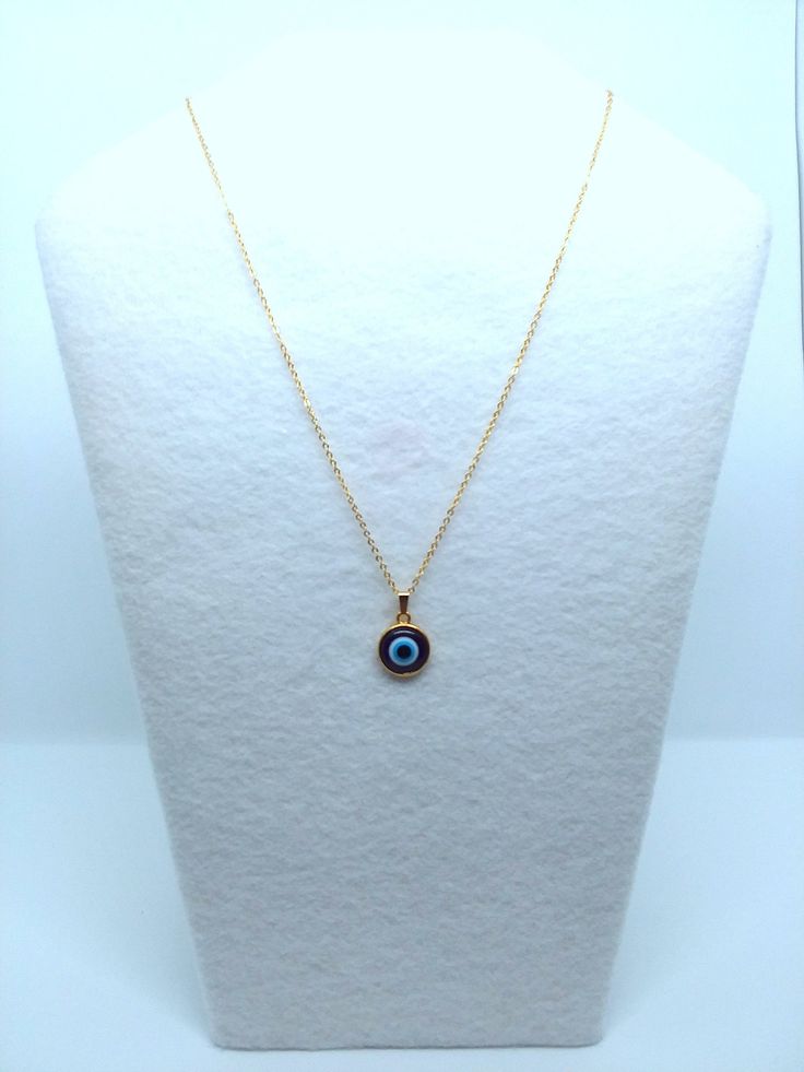 Evil Eye Pendants in Gold/Silver Tone. Cabochon bezel is hand-painted with Ultramarine Blue acrylic paint to enhance the charm. 12mm blue resin evil eye charm is resin set into alloy metal cabochon bezel. Chain length is 18 inches. Silver chain is stainless steel and gold chain is gold plated brass. Charm length and width is 1/2 inch. Has an upgraded lobster clasp closure on the back. Back of cabochon bezel is also coated in a protective UV gel to avoid tarnishing. Jewelry Cloth & Wear/Care Evil Eye Enamel Jewelry As A Gift, Evil Eye Enamel Jewelry Gift, Nickel-free Blue Metal Charm Necklaces, Metal Evil Eye Necklace With Round Shape, Evil Eye Metal Necklace With Round Shape, Evil Eye Round Metal Necklace, Metal Evil Eye Jewelry, Hypoallergenic Blue Circular Jewelry, Blue Metal Charm Necklace With Round Pendant