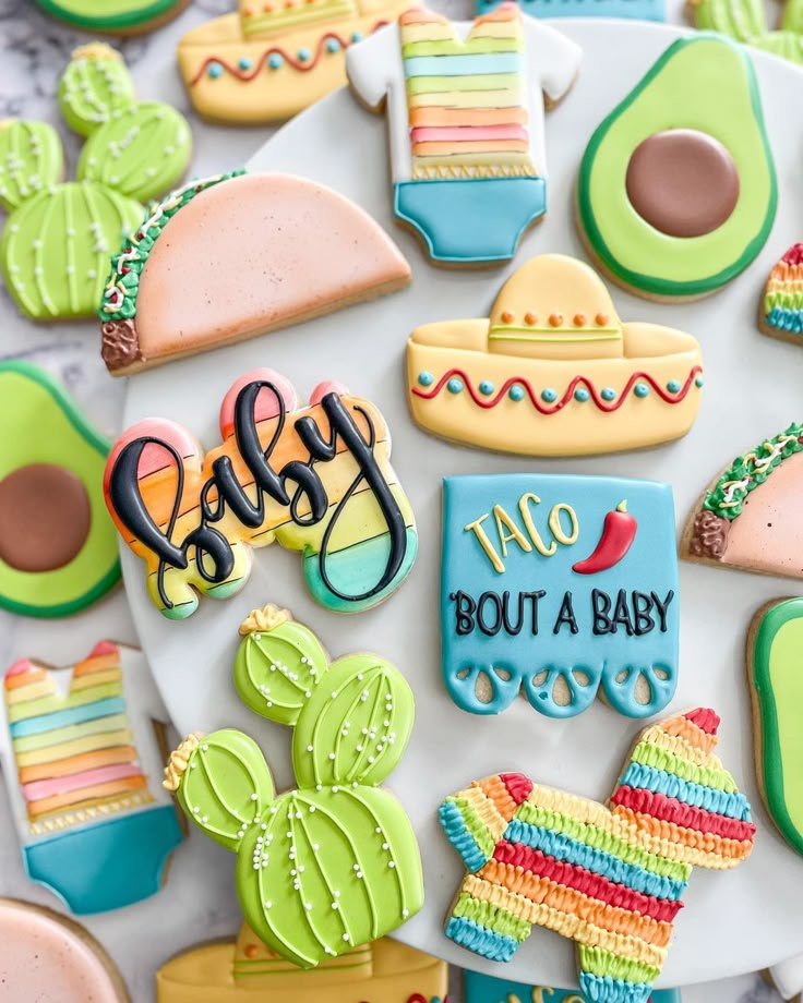 decorated cookies are arranged on a plate with the words baby, no but a baby