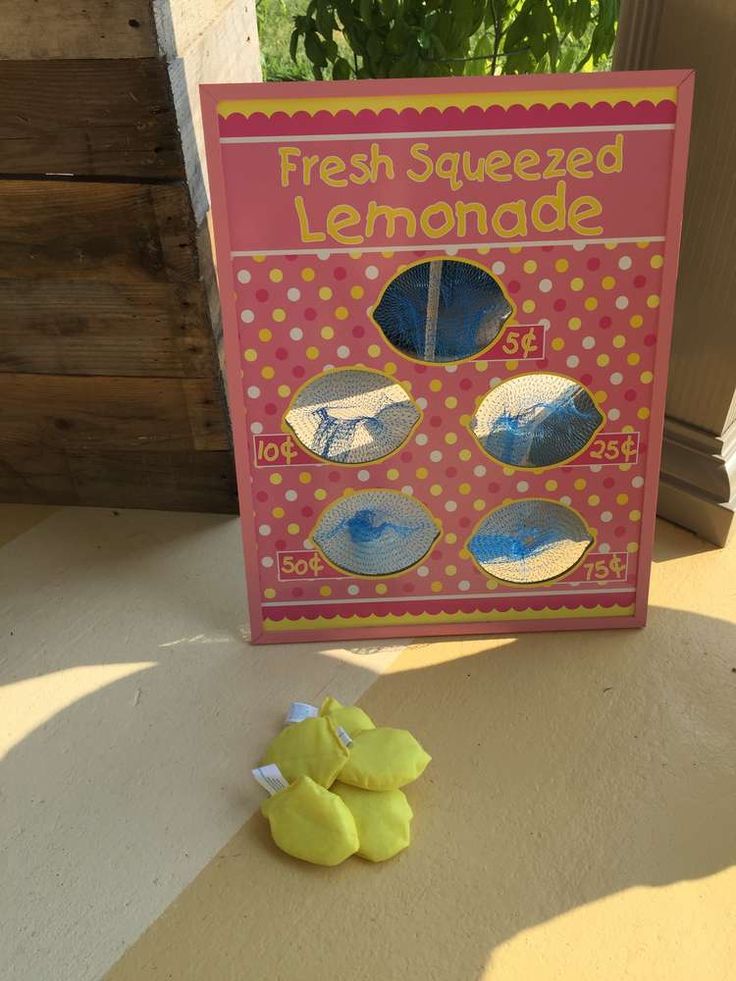 a box of fresh squeezed lemonade sitting on the ground