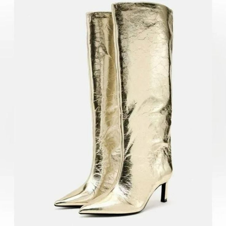 Heeled Knee High Boots. Metallic Effect. Pointed Toe. Heel Height: 2.6 Inches (6.5 Cm) Elegant Metallic Boots With Pointed Toe, Elegant Metallic High Heeled Boots, Glamorous Metallic Pointed Toe Boots, Gold Heeled Boots With Reinforced Heel For Fall, Chic Metallic Heeled Boots For Formal Occasions, Chic Metallic Boots For Formal Events, Chic Metallic Boots For Formal Occasions, Gold Leather Heeled Boots With Reinforced Heel, Gold Evening Boots For Spring