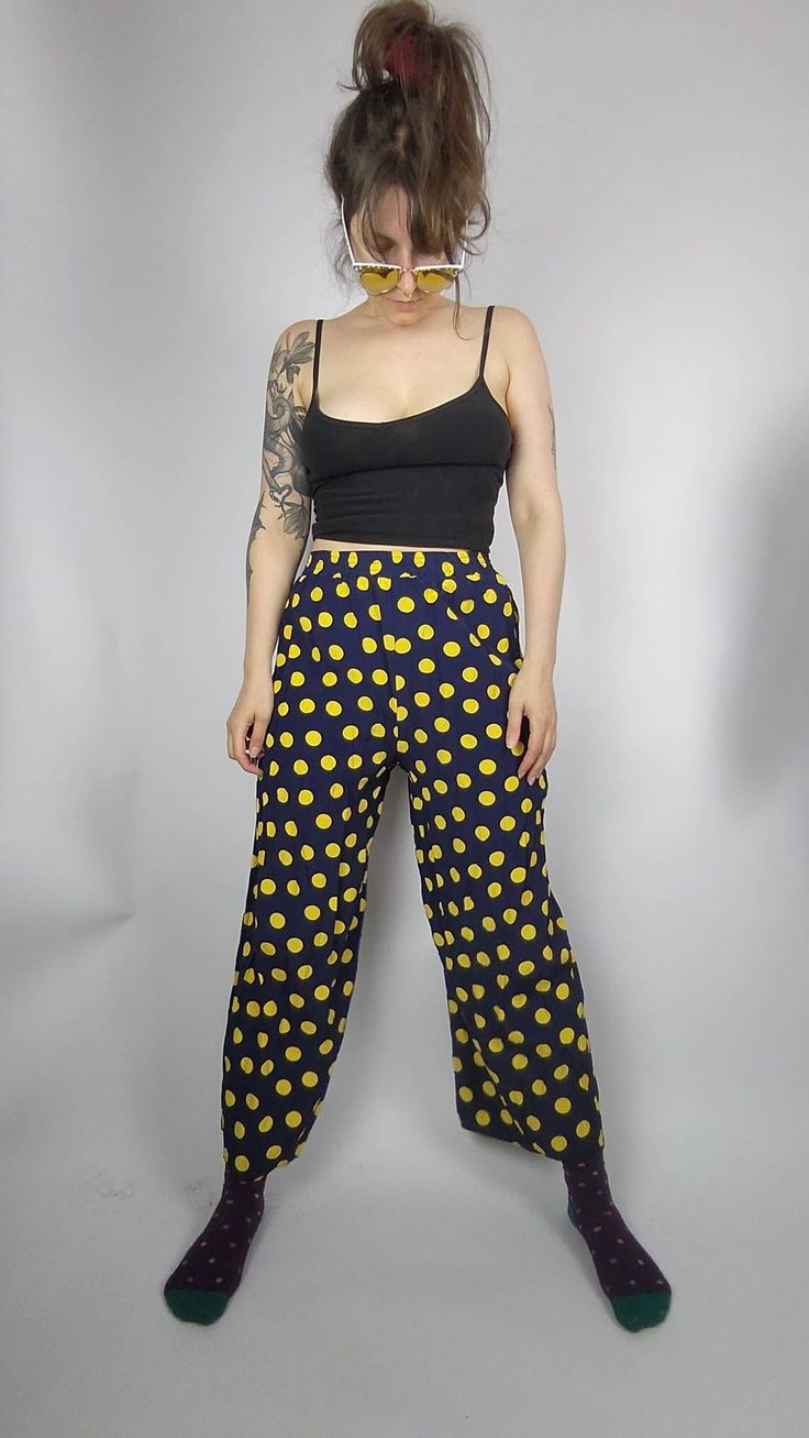 You are looking for a comfy but also stylish summer pants? These wonderful darkblue midi pants are printed with big yellow dots that bring the sunshine right to you.  DETAILS: no size label, seems like S, check measurements below navy blue with yellow polkadots wide leg style comfy fit elastic waistband light summer fabric Vintage condition: VERY GOOD there is a tiny irritation in the fabric at one side and small hole above it at the waistband  length: 95cm waist width: 30 - 45cm (stretchy) wais Retro Relaxed Fit Long Bottoms, Retro Relaxed Fit Long Pants, Retro Relaxed Fit Bottoms With Elastic Waistband, Retro Straight Pants Relaxed Fit, Retro Relaxed Fit Straight Pants, Relaxed Fit Retro Straight Pants, Casual Polka Dot Cotton Bottoms, Polka Dot Summer Bottoms With Pockets, Polka Dot Wide Leg Pants With Elastic Waistband