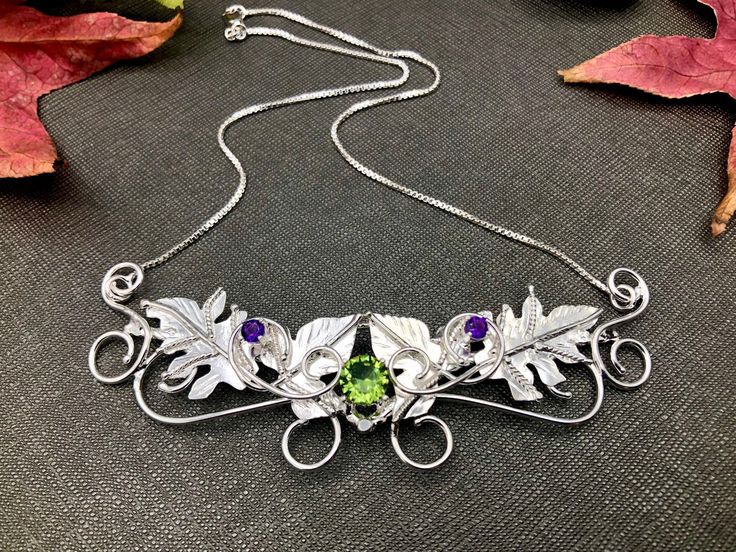 I've handmade this beautiful rustic themed Woodland Leaves Necklace keepsake, perfect for a Woodland wedding theme, or any event, casual or high end, you desire! I've designed this in sterling silver with 3 gemstones. The top two are 4mm round faceted natural amethysts complete with a center 8mm faceted rainbow Topaz. The leaf work design is approximately 3.5 inches wide with a 13 inch chain soldered to either end for an approximate length of 16 or so inches. If you prefer it shorter or longer, Artisan Wedding Necklaces With Unique Variations, Nature-inspired Pendant Jewelry For Crafting, Handmade Silver Whimsical Jewelry, Nature-inspired Sterling Silver Necklaces With Unique Variations, Whimsical Handmade Silver Jewelry, Whimsical Handmade Necklaces For Weddings, Nature-inspired Sterling Silver Wedding Necklaces, Nature-inspired Sterling Silver Necklace For Weddings, Whimsical Sterling Silver Wedding Jewelry