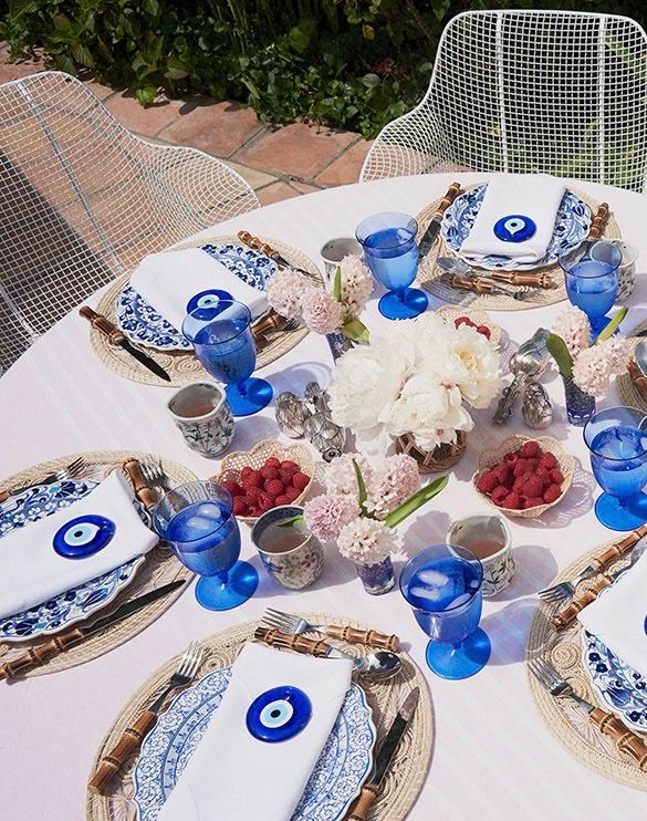 the table is set with blue and white dishes