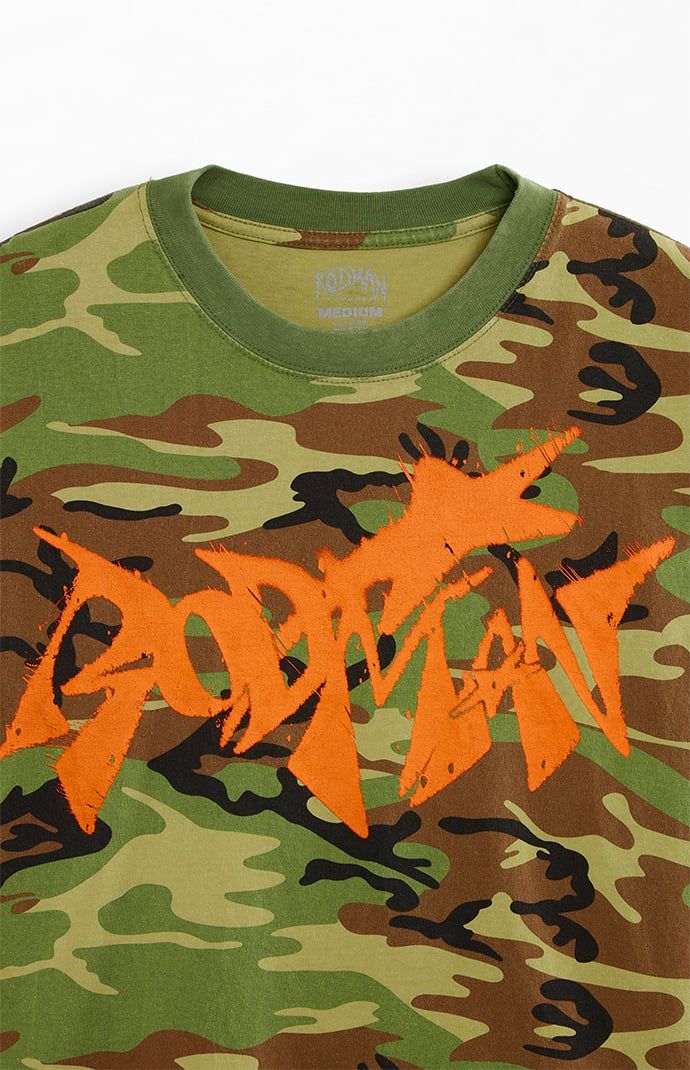 The Star Camo T-Shirt from Rodman Apparel features a relaxed fit, a striking camo print, and bold graphics. This standout piece combines comfort with an eye-catching design, making it a perfect addition to any casual wardrobe.


	Crew neckline
	Short sleeves
	Drop shoulder
	Relaxed fit
	Front & back graphics
	Machine washable Slim Fit Cargo Pants, Curve Jeans, Jeans Kids, Kids Swimwear, Bold Graphics, Slim Fit Pants, Oversized T Shirt, Camo Print, Oversized Tee