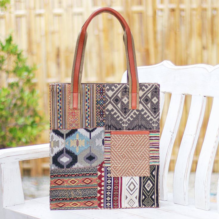 Designed with geometric motifs and lots of extra pockets Thai artisan Chirada's gorgeous tote bag is practical as well as stylish. Woven from a poly-cotton blend the bag features lots of contrasting designs and a cotton and leather handle. Inside one zippered pocket and two open pockets give you a place for odds and ends while a dark cotton lining keeps things cushioned. A zippered closure and two outside pockets finish the bag with thoughtful details. Multicolor Canvas Bag With Pockets, Patchwork Canvas Shoulder Bag For Travel, Bohemian Canvas Tote Shoulder Bag, Geometric Bags With Removable Pouch For Daily Use, Canvas Patchwork Bags For Everyday Use, Rectangular Bags With Geometric Pattern, Everyday Canvas Patchwork Bags, Rectangular Bag With Geometric Pattern For Daily Use, Rectangular Bags With Geometric Pattern For Daily Use