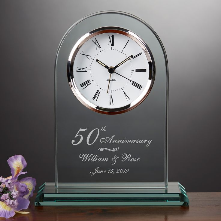 a glass clock with a poem on the front and back of it next to a purple flower