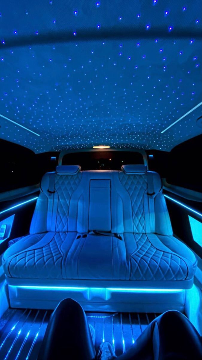 the interior of a car with blue lights