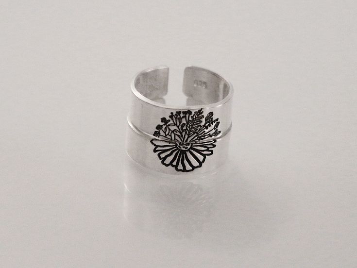 This two-ring set features one ring with a half daisy and the other half with a bunch of wildflowers. The perfect two-ring set for everyday wear for your best friend, partner, or sibling. This unique design is great for everyday wear. Product Details: Materials: Aluminum, Sterling Silver, Fine Silver, 14k Gold Filled Color: Silver, Gold, Rose Gold Size: 6mm Two Matching Rings You will receive two hand-stamped rings filled with a black enamel finish. Adjustable Flower Ring For Everyday Wear, Matching Ring Set, Hand Stamped Ring, Stamped Rings, For Your Best Friend, Matching Ring, The Other Half, Other Half, Matching Rings