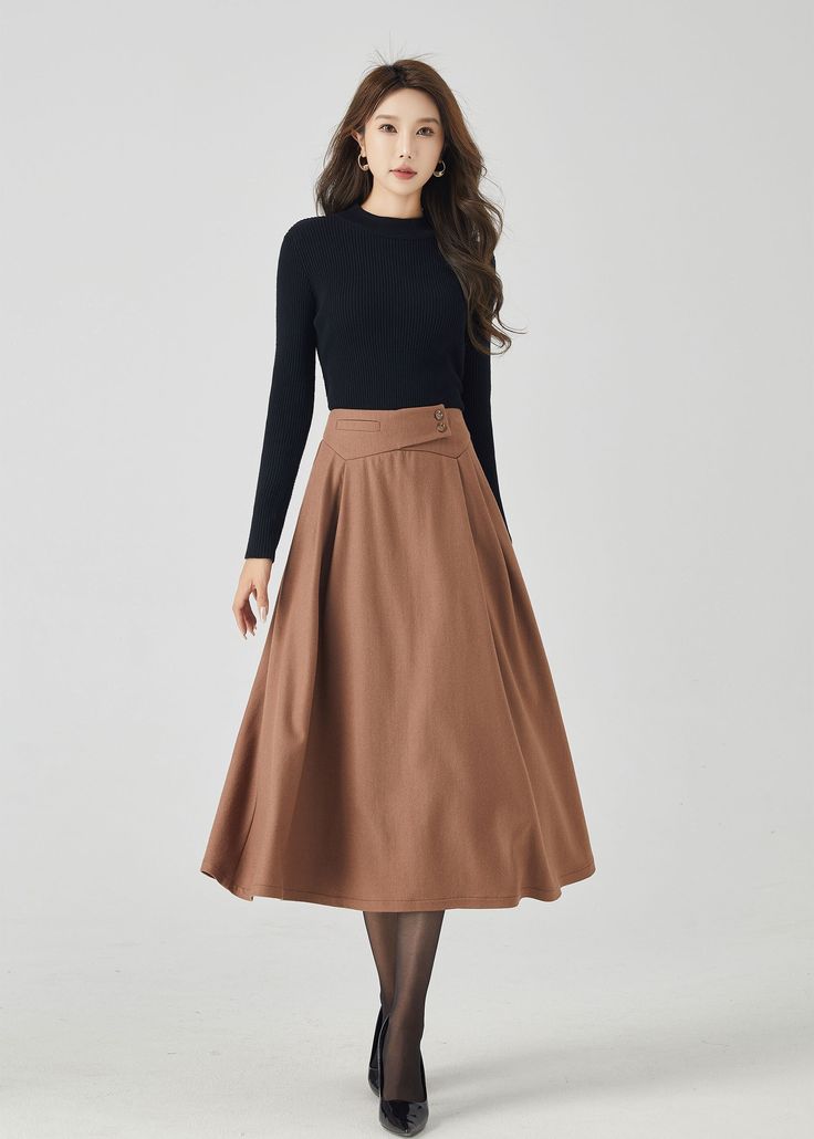 "Discover our classic brown wool A-line skirt, a timeless addition to your winter wardrobe. The rich brown color exudes sophistication, while the premium wool fabric ensures warmth and comfort. This versatile A-line skirt is perfect for both work and casual outings, making it a must-have choice for staying chic and cozy. DETAILS * 30% wool blend, 40% fiber and polyester, 40% nylon * Full polyester lining * Without pocket * Back zipper closure * Vintage inspired skirt * Suitable for autumn and winter  * Mid calf length * Dry clean MODEL SIZE Bust 85 cm(33.4\") Waist 67 cm(26.7\") Height 168cm (5' 6\") She wears size XS Choose CUSTOM Order if you * Need other color * Can't find your size in our size Chart * Chang the Length * Your Height is not Between 5'1\" - 5\"9\" * Your weight is not fro Classic A-line Pleated Skirt For Fall, Beige A-line Pleated Skirt For Fall, Elegant Solid Pleated Skirt For Winter, Fitted A-line Brown Maxi Skirt, Elegant A-line Fall Skirt, Knee-length Maxi Skirt For Workwear In Fall, A-line Skirt For Workwear In Fall, Beige A-line Skirt For Fall, Winter Fitted Brown Maxi Skirt