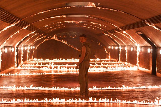 a man standing in a tunnel filled with fire