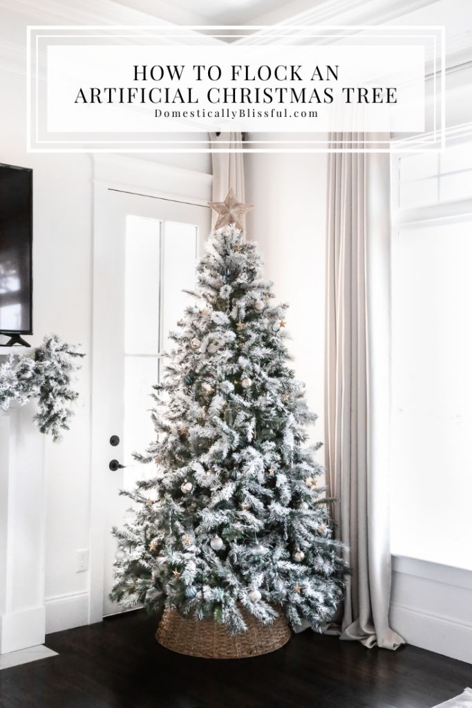 a white christmas tree sitting in the corner of a room