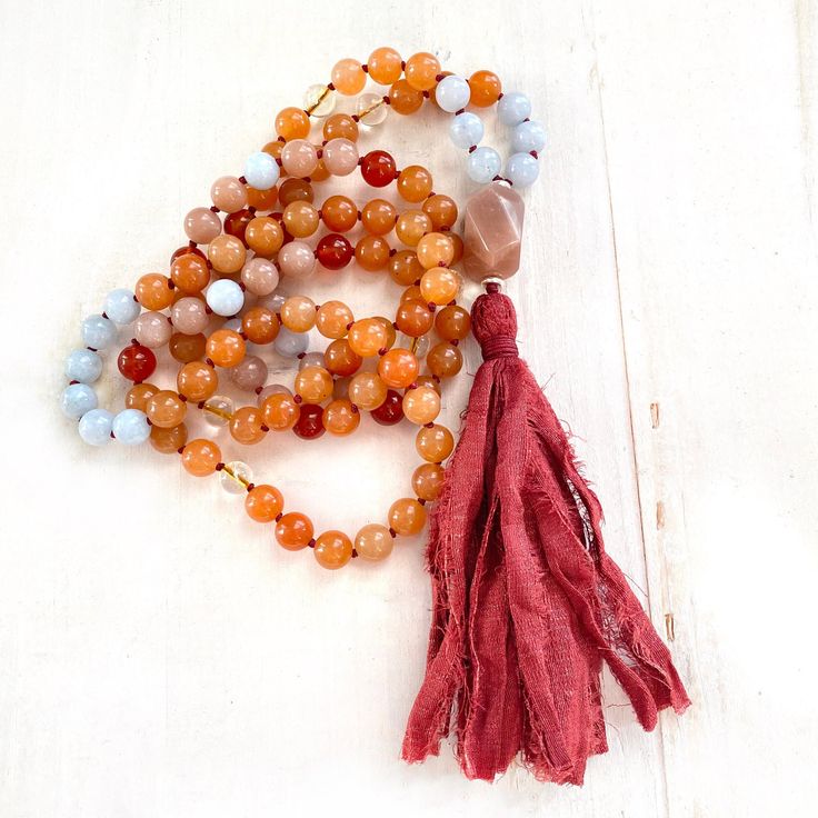 "A wonderful Mala for helping with insecurities. Handcrafted with Aquamarine for support when feeling overwhelmed and Peach Aventurine for assistance when making decisions. This Mala also consists of Sunstone which is known as a stone of leadership and personal power along with Carnelian to calm temper and give a sense of humor. An accent stone of Citrine is worked in for joy and happiness. All these healing stones are hand knotted into this beautiful 108 bead Mala. Charm not included, please se Spiritual Hand-strung Amber Beaded Necklaces, Orange Jewelry With 108 Beads For Meditation, Bohemian Orange Jewelry For Meditation, Orange Spiritual Necklace With 108 Beads, Aventurine Gemstone Beads Necklace For Healing, Spiritual Orange Jewelry With Faceted Beads, Hand-strung Orange Beads As A Gift, Orange Spiritual Beaded Necklace With Natural Stones, Spiritual Orange Beaded Necklace With Natural Stones