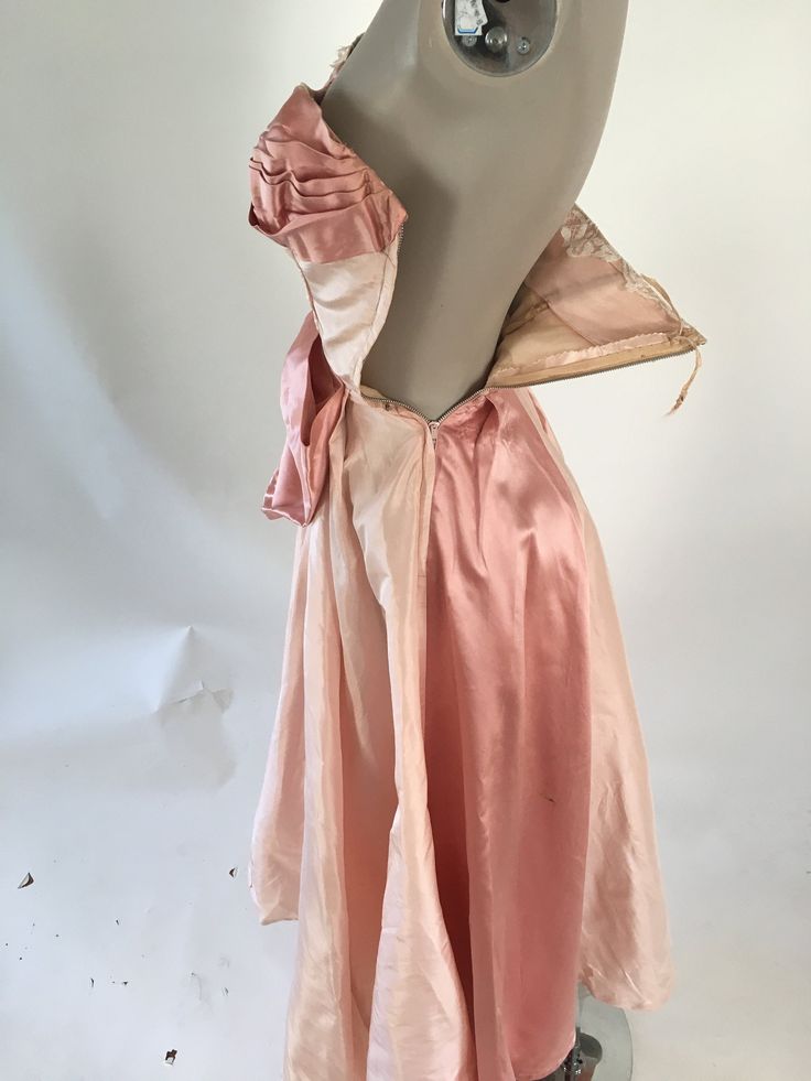 "1950's couture silk ball gown with a satin stripe and enormous bow. Metal side zipper. Discoloration and some shattering under arms is covered by lace. Several very small holes in the skirt, do not affect the integrity of the dress Size XS Bust: 32\" Waist: 23\" Hips: free Skirt Length: 42\"" Vintage Silk Evening Dress With Fitted Bodice, 1950s Style Silk Party Dress, 1950s Style Silk Dresses For Vintage Events, Vintage Ball Gown Dress For Party, Vintage Evening Ball Gown Dress, Vintage Evening Dress With Boned Bodice, Vintage Silk Ball Gown, Vintage Ball Gown With Boned Bodice, Vintage Party Dress With Bow