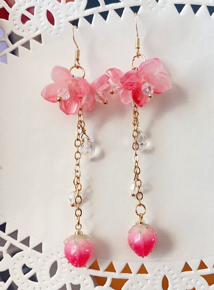 pink Sakura Flower Earrings The pink sakura flower earrings feature there glazed sakura and one plastic flower drop. They are really comfortable for everyday wear.  Available in GOLD and Silver finish! M A T E R I A L S * A N D * S I Z E  The hook is 14K gold filled - Length: 80mm(without the hook) - Width: 23mm