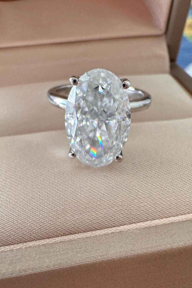 an oval cut diamond ring in a box