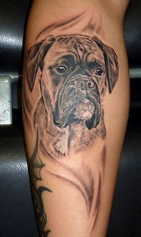 a black and grey dog tattoo on the leg