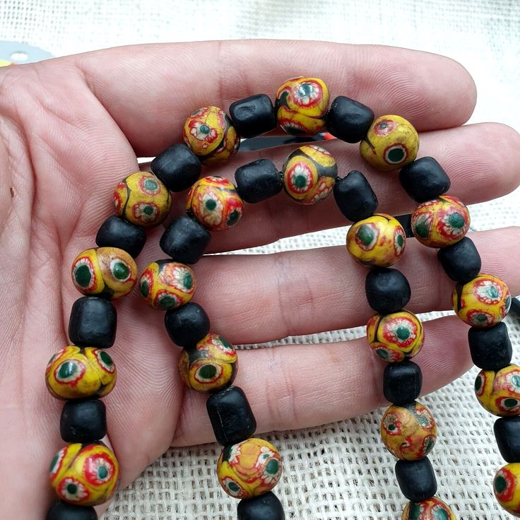 Vintage Black Yellow, green Gabri Eyes Glass Beads Strand Necklace Vintage African Gabri Style Eyes Beads Strand  * Condition: Good to fair.  * See picture with Size measurement tool for size comparison.  * Strand Length 24 inches (includes string/raffia) * Brand: Unbranded  * Style: Beaded  * Type: Strand of beads                        SHIPPING,PAYMENT,                        RETURN,FEEDBACK 1:We Freely Ship all our items to all over the world via Airmail Register Thailand with pr Green Wooden Beaded Bracelets, Green Wooden Beads For Festival, Green Wooden Beads For Festivals, Unique Green Wooden Beaded Bracelets, Green Jewelry With Black Beads For Gift, Green Jewelry With Black Beads As A Gift, Yellow Necklace With Round Black Beads, Green Wooden Beads Jewelry For Festival, Artisan Black Beaded Bracelets With Colorful Beads