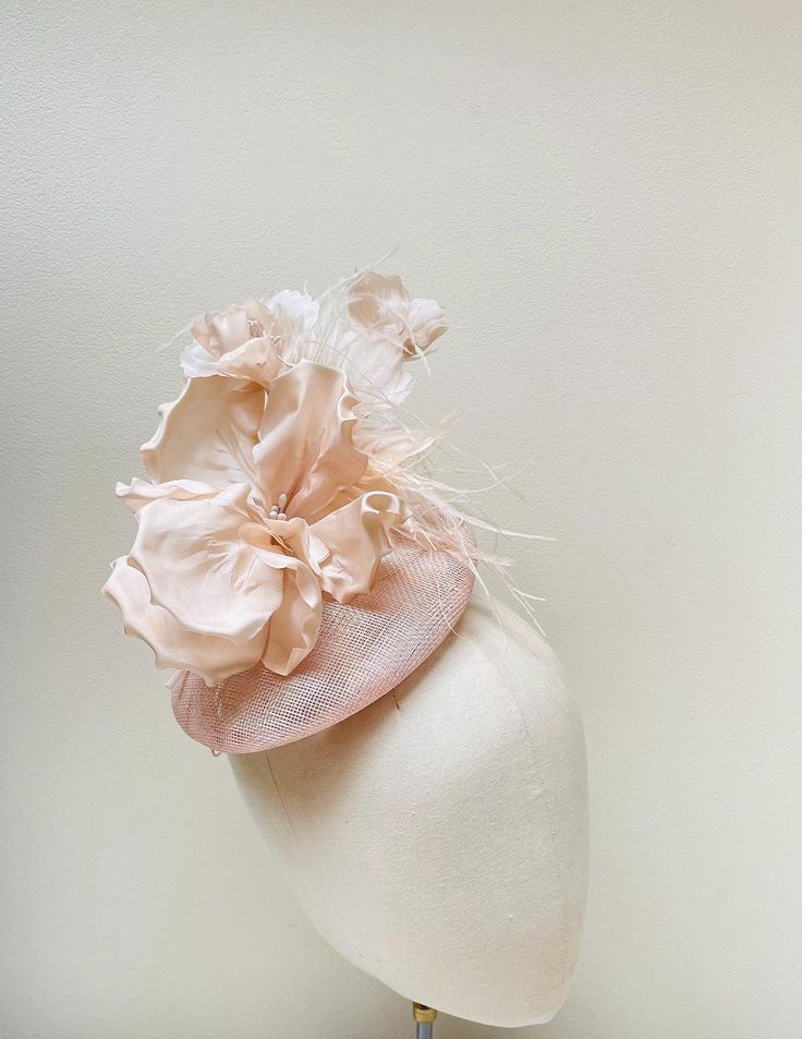 FABRIC This Women's pale blush sinamay hat fascinator is embellished with luxury wired mixed flowers including a feature fuchsia poppy. Easy to wear with a millinery elastic. PACKAGING Each headband is wrapped in pretty acid free tissue paper, sealed with an Evierosemade brand sticker and shipped in an eco-friendly cardboard gift box to protect while in transit. If you are purchasing as a gift, please select "This order is a gift" (the item price will not be included in the gift box). If you would also like to add a personalised message to the recipient, please enter your message in the box marked "Add a Note to evierosemade". Please don't hesitate to get in touch with me via the "Ask a Question" Button, if you have any queries. INTERNATIONAL ORDERS: Sent via tracked mail. Please note that Spring Adjustable Sinamay Fascinator, Summer Feminine Fascinator, Summer Feminine Fitted Fascinator, Adjustable Sinamay Headpiece For Spring, Spring Beige Fascinator With Handmade Flowers, Feminine Hats For Wedding And Royal Ascot, Spring Fascinator With Sinamay And Curved Brim, Cream Summer Fascinator With Handmade Flowers, Elegant Summer Fascinator With Handmade Flowers