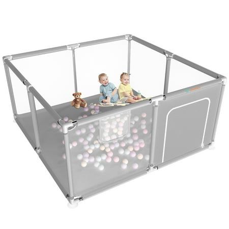 two babies playing in a playpen with balls