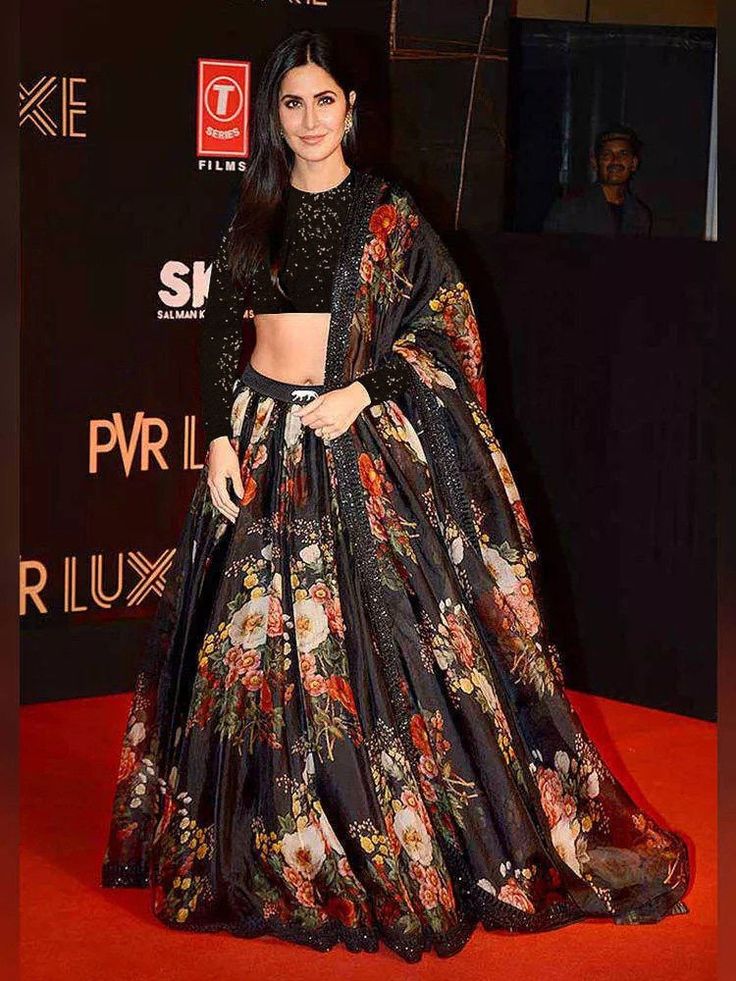 You are about to make the most beautiful party look by wearing this Sabyasachi designer lehenga choli.  This black lehenga in organza material embellished with floral print all over. Comes with black color choli decoded with full sequins work all over and black dupatta with similar floral print all over.  This lehenga choli is semi-stitched, can be customized up to 44 sizes.The black lehenga comes with can-can in the side.   This party wear lehenga choli is showcased by Katrina Kaif.        Pric Black Lehenga Choli, Sabyasachi Lehenga, Black Lehenga, Organza Lehenga, Indian Outfits Lehenga, Floral Lehenga, Indian Salwar Kameez, Lehenga Choli Online, Party Wear Lehenga