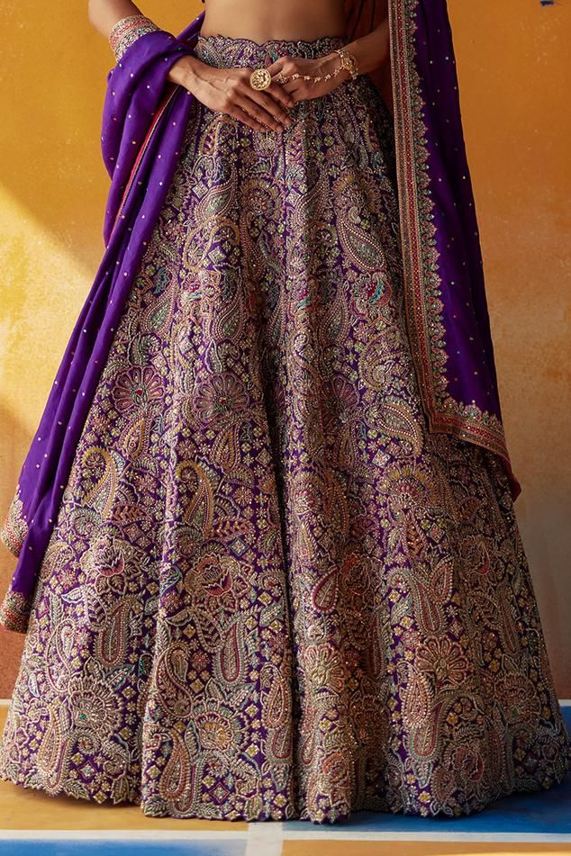 Purple raw silk attached cancan lehenga with all over floral, paisley embroidery in resham and zardozi work. Paired with a padded blouse with resham, zardozi and badla checks texture embroidery. Comes along with a dupatta with embroidered border.
Components: 3
Pattern: Embroidery
Type Of Work: Resham, Floral, Zardozi
Neckline: Leaf Neck
Sleeve Type: Half Sleeves
Fabric: Blouse and Lehenga: Raw Silk, Dupatta: Pure Silk.
Color: Purple
Other Details: 
Lehenga:
Length: 46 inches
Attached cancan
Blou Multicolor Silk Thread Lehenga For Wedding, Traditional Banarasi Silk Gown With Zari Work, Purple Traditional Wear With Pallu For Reception, Traditional Tilla Gown For Ceremonies, Raw Silk Lehenga With Motifs For Wedding, Raw Silk Traditional Wear With Tilla For Wedding, Wedding Lehenga In Raw Silk With Motifs, Purple Embroidered Fabric With Zari Work For Traditional Ceremonies, Traditional Brocade Gown With Traditional Drape