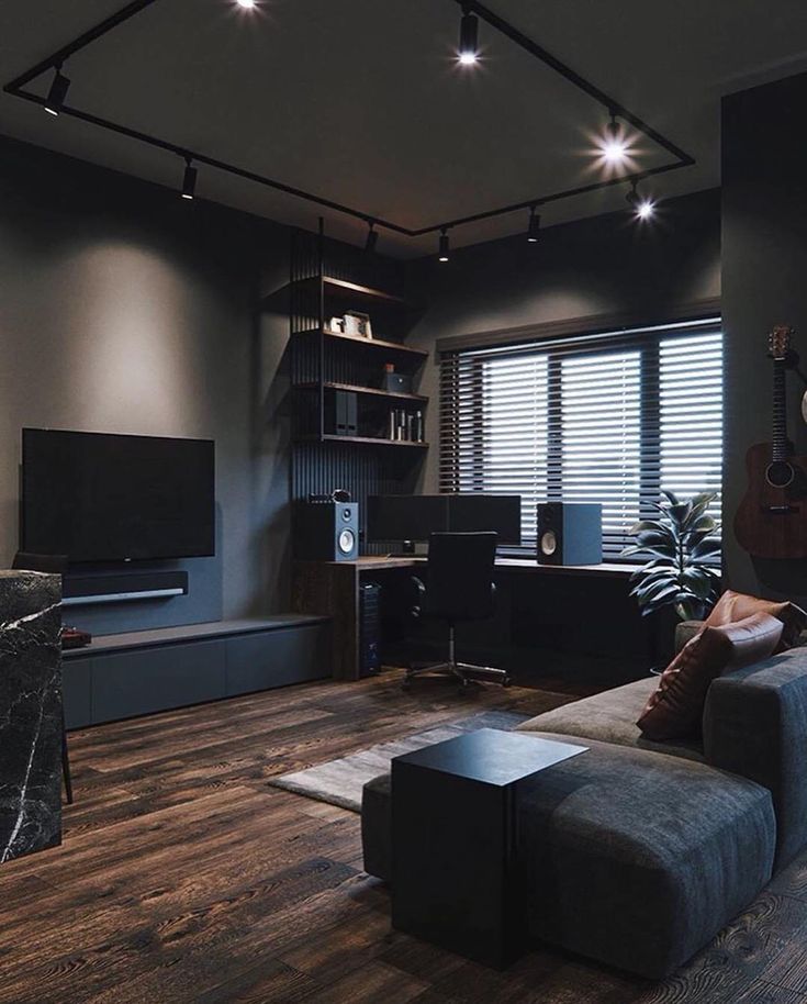 a living room filled with furniture and a flat screen tv on top of a wooden floor