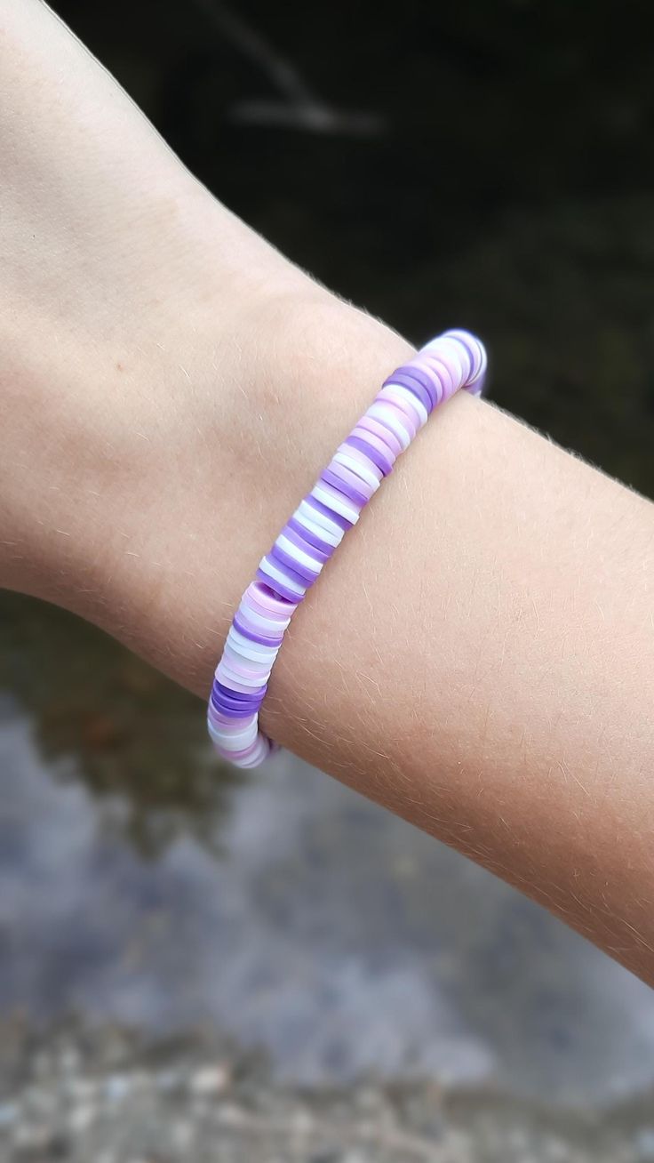 This super cute clay bead bracelet is made with high quality beads. It has a randomized pattern with the colors: -dark purple -light purple -white.  Please note that colors and pattern may vary from each bracelet. All bracelets vary from 6.5 inches to 6.75 inches.  While the string I use is high quality, be careful not to overstretch the bracelet as it will shorten its lifespan. In addition, keep out of water as it will shorten the lifespan of the bracelet. Excessive sweating and water exposure may also rust any gold beads if there are any gold beads on the bracelet.  WARNING: keep out of reach of children as this product is a choking hazard. Purple Polymer Clay Bead Bracelet, Casual Purple Friendship Bracelets With Letter Beads, Casual Purple Friendship Bracelet With Letter Beads, Trendy Purple Friendship Bracelets With Colorful Beads, Casual Purple Bracelets With Colorful Beads, Casual Purple Hypoallergenic Bracelets, Cute Purple Bracelets With Colorful Beads, Cute Purple Bracelet With Colorful Beads, Casual Purple Beaded Bracelet With Colorful Beads