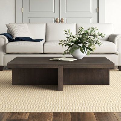 a living room with a white couch and coffee table