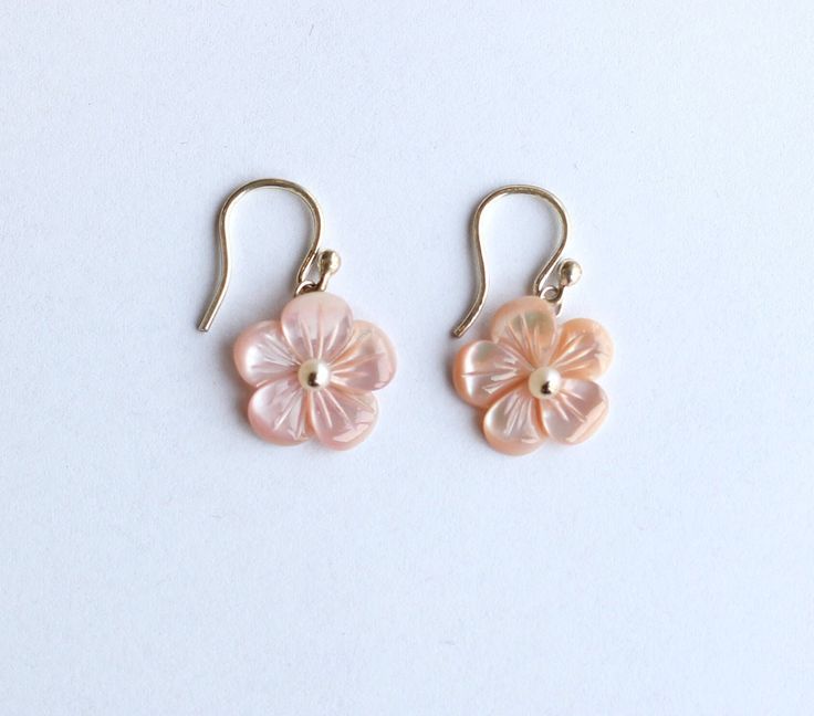 "These earrings are from our Flower Collection. Each piece in this collection features one or more hand-carved genuine stone flowers. Hand-sculpted from pink Mother of Pearl into beautiful floral blooms, the flowers measure 15mm and have white Fresh Water Pearls at their centers.  Earring Length: 1.13\" Closure: S Hook" Pink Flower Shaped Pierced Earrings, Delicate Pink Pierced Earrings, Feminine Flower Jewelry With 3d Flowers, Feminine 3d Flower Jewelry, Delicate Pink Earrings, Pink Birth Flower Earrings For Wedding, Flower Shaped Pearl Earrings With 3d Flowers As Gift, Pink Round Earrings With Flower Charm, Pink Sterling Silver Flower Earrings For Wedding