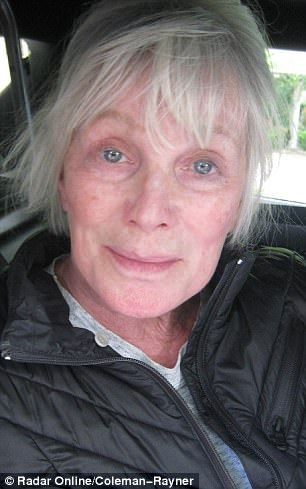 an older woman sitting in the back seat of a car with her eyes wide open