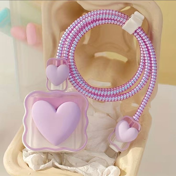 there is a pink and purple object in the shape of a earphone with a cord attached to it