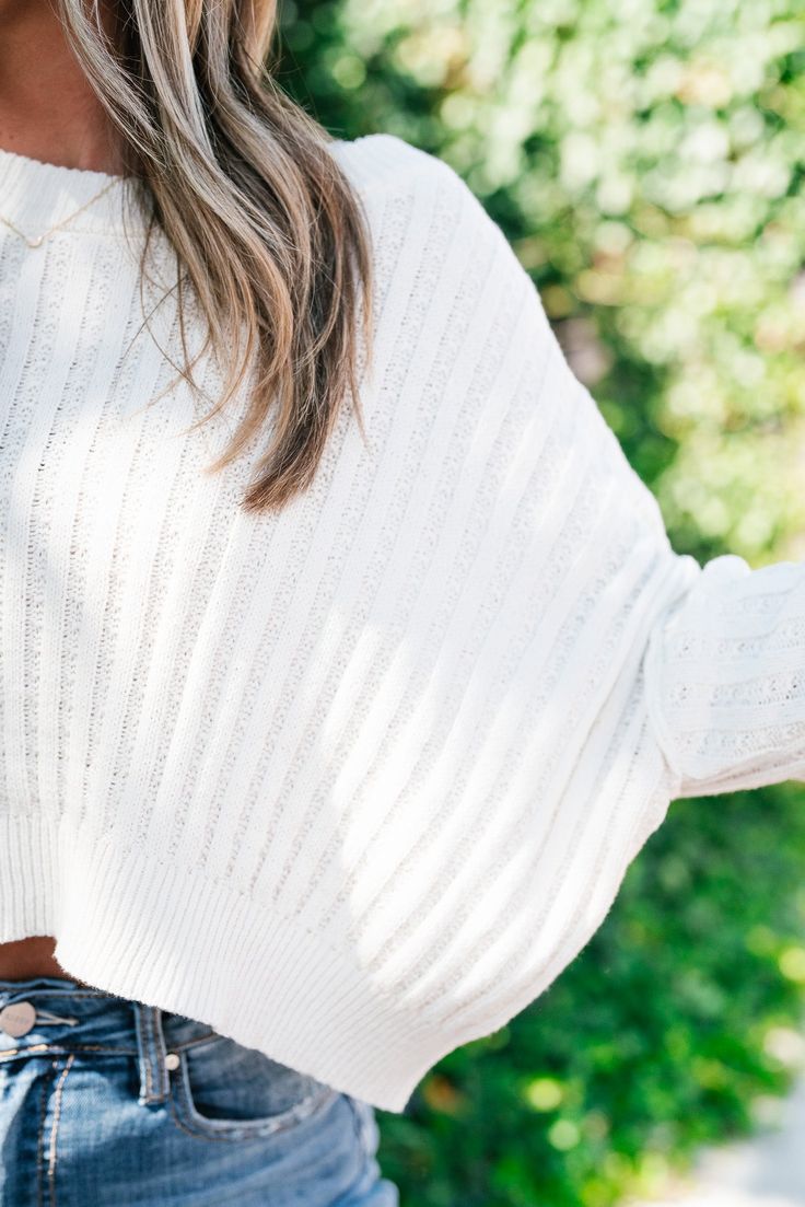 Embrace effortless style and comfort with our Ivory Cozy Calling Cropped Sweater. This elegant sweater in a soft ivory hue is designed to keep you warm while adding a contemporary touch to your ensemble. The cropped length provides a modern silhouette, perfect for pairing with high-waisted jeans, skirts, or tailored trousers. Crafted from a luxurious, lightweight knit fabric, this sweater offers a cozy feel without compromising on style. The relaxed fit ensures all-day comfort, while subtle desi Chic Stretch Cropped Sweater In Soft Knit, Chic Cream Soft Knit Cropped Sweater, Cream Knit Cropped Sweater For Spring, Trendy Cream Cropped Sweater For Spring, Spring Cream Knit Cropped Sweater, Chic Soft Knit Cropped Sweater, Chic Cropped Sweater For Winter Loungewear, Chic Beige Ribbed Cropped Sweater, Beige Stretch Chic Cropped Sweater