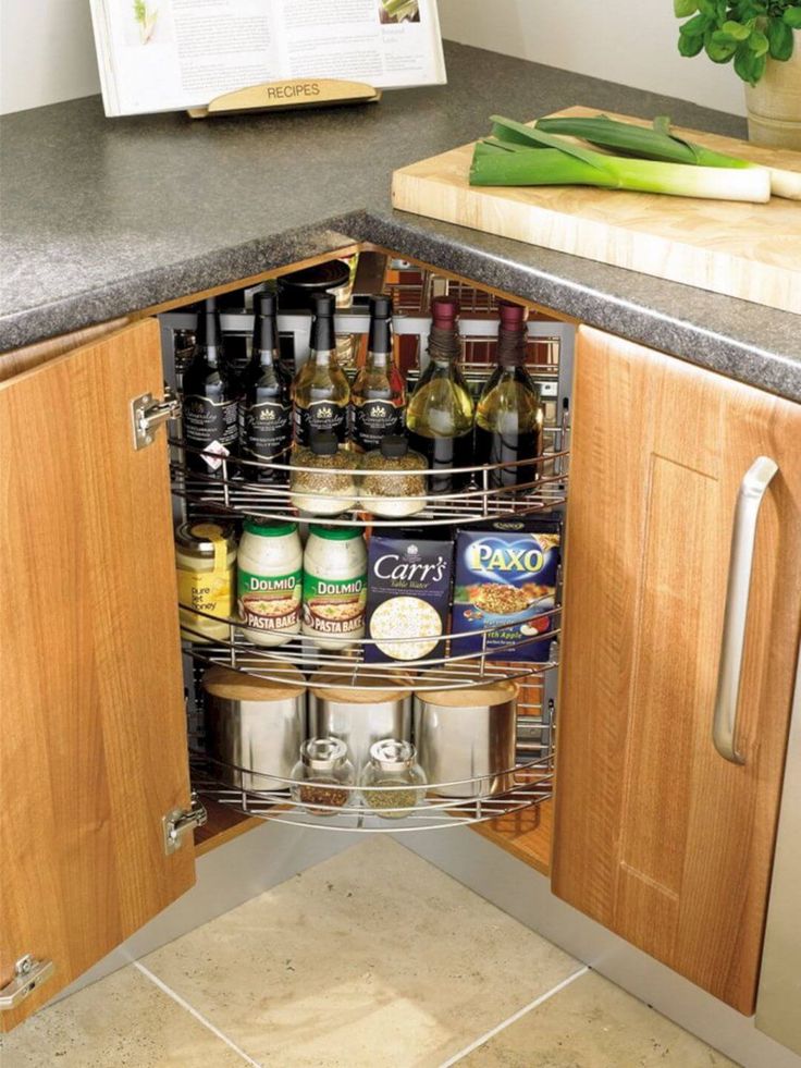 an open cabinet in the corner of a kitchen