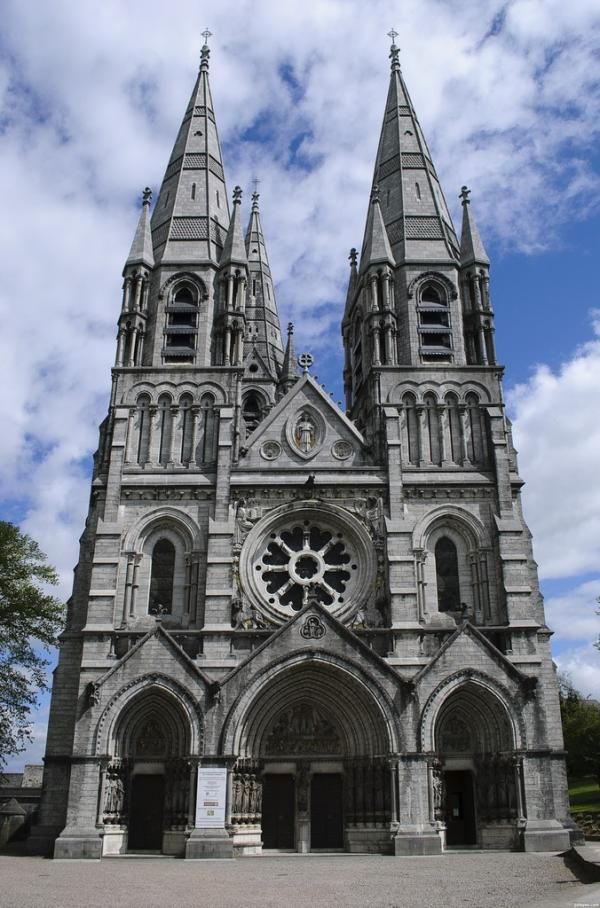 an old church with two towers and a clock on it's front door is shown