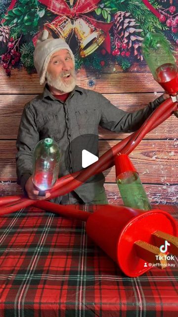 the man is holding a large pipe on top of a wooden table with christmas decorations