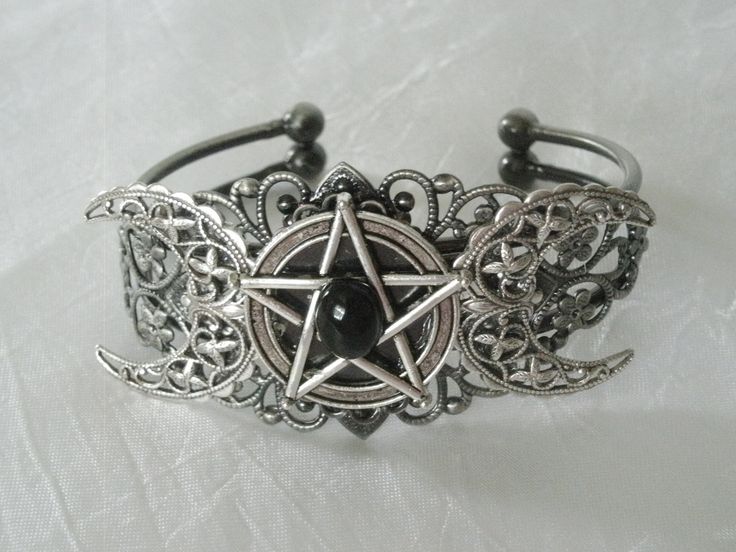 This beautiful silver plated filigree cuff bracelet has a silver plated triple moon design and a pewter silver pentacle with an obsidian setting. Adjustable. Mystical Silver Jewelry With Intricate Design, Adjustable Mystical Silver Bracelet, Adjustable Silver Mystical Bracelet, Silver Gothic Bracelets For Halloween, Gothic Silver Bracelets For Halloween, Adjustable Silver Gothic Jewelry, Gothic Bangle Bracelet For Gift, Gothic Silver Jewelry For Festival, Adjustable Gothic Silver Jewelry