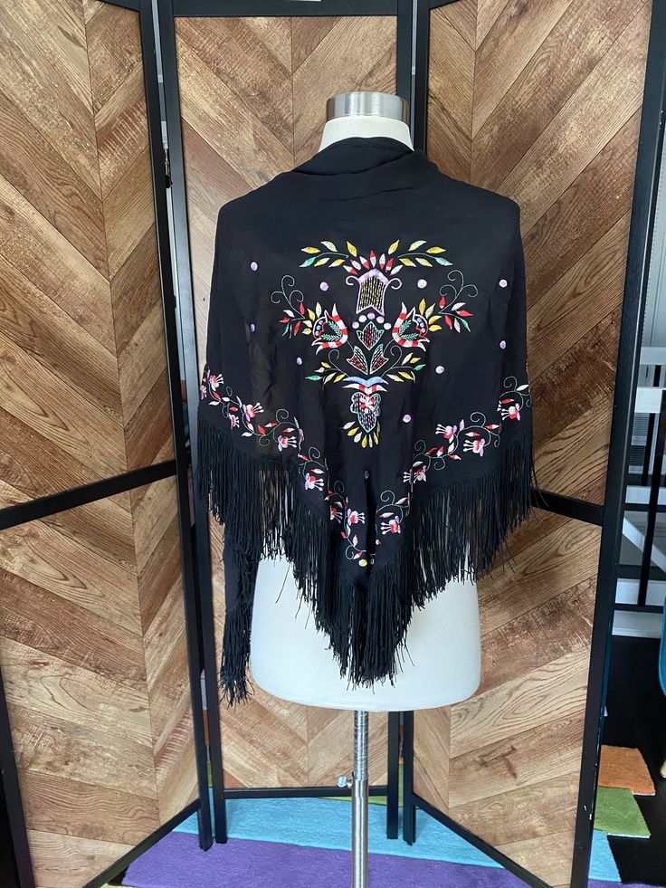 "1970's does 1920's black shawl with fringe and colorful embroidery. Very lightweight, excellent vintage condition.  66\" length 29\" tall (excluding fringe" Embroidered Folk Shawl One Size, One Size Folk Embroidered Shawl, One Size Embroidered Folk Shawl, Black Bohemian Shawl For Fall, Black Bohemian Shawl For Spring, Traditional Black Shawl One Size, One Size Festival Shawl With Fringe, Multicolor Fringe Shawl For Spring, Black Bohemian Scarf For Fall