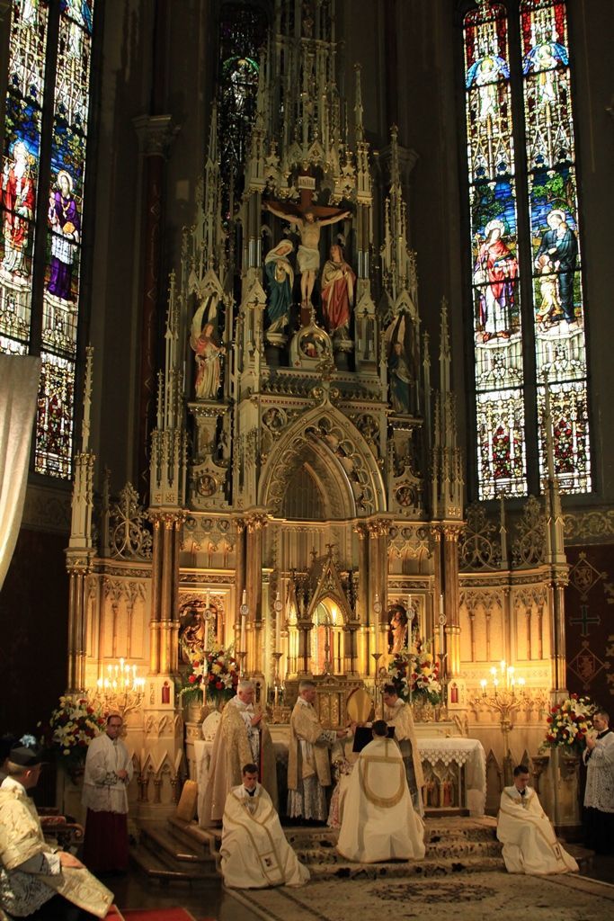 a group of people standing in front of a church alter