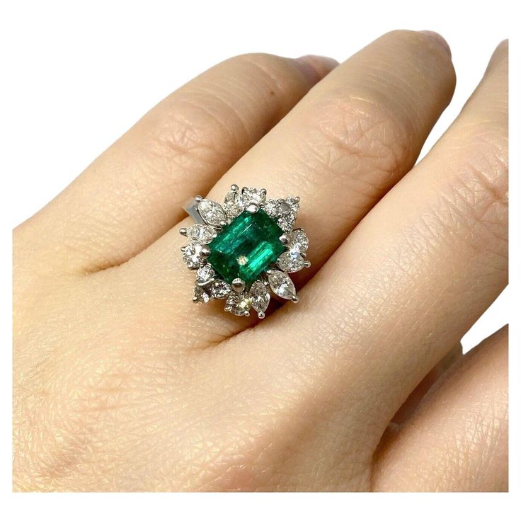 GIA Certified Emerald in a Vintage Diamond Setting 18k White Gold Colombian Emerald & Diamond Ballerina Ring features a 1.62 carat Natural Emerald with beautiful vibrant green color accented by 6 Marquise and 10 Round Brilliant Diamond set in a 18k White Gold Ballerina setting. Emerald weight is 1.62 carats, is of Colombian origin, and is GIA certified (please see copy of certificate in the photo gallery). Total diamond weight is 1.00 carats. The ring dimensions are 0.67 inches by 0.68 inches, and it rises 0.40 inches above the finger. Ring size is 6.25 Ring weighs 7.2 grams. Set in a 18k White Gold Ballerina setting. Hallmarks: 18k BUY WITH CONFIDENCE Authenticity is guaranteed for every item we sell. Diamond Ballerina Ring, Ballerina Ring, Colombian Emeralds, Diamond Settings, Diamond Set, Vibrant Green, Finger Ring, Emerald Diamond, Brilliant Diamond